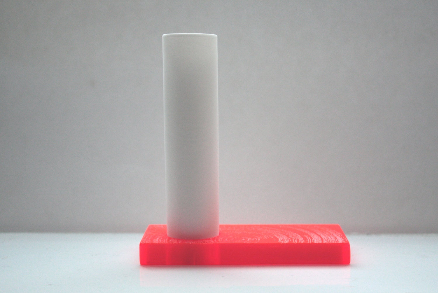 Mini tube vase made out of stoneware English fine bone china and an orange acrylic base