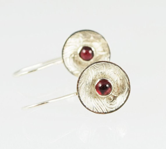 Sterling silver  round cup earrings, textured and set with 4mm garnet cabochons.