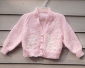 Size 6 months, Pink cardigan with white bunny rabbits for baby girl.