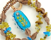 SOLD    Teal and Mustard Lampwork Pendant Necklace