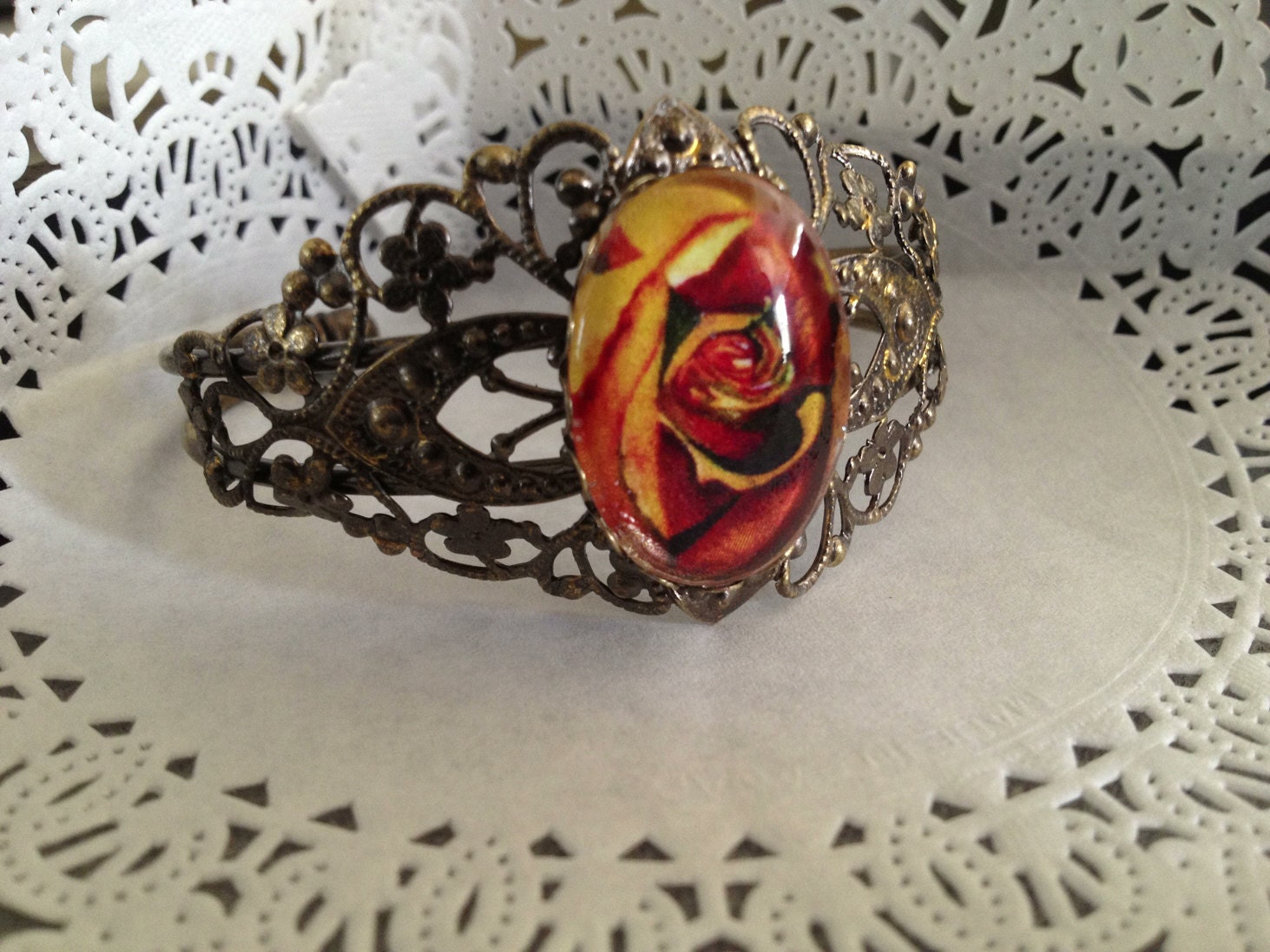 1 beautiful Filigree Bracelet with 18 x 25 mm image on the pad. This is a bracelet made of copper and bronze plated.