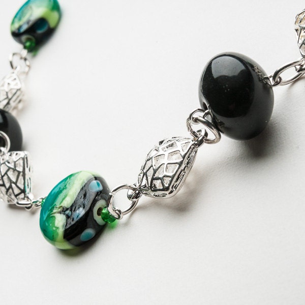 Chunky black and aqua statement necklace with silver spacer and black jersey tie