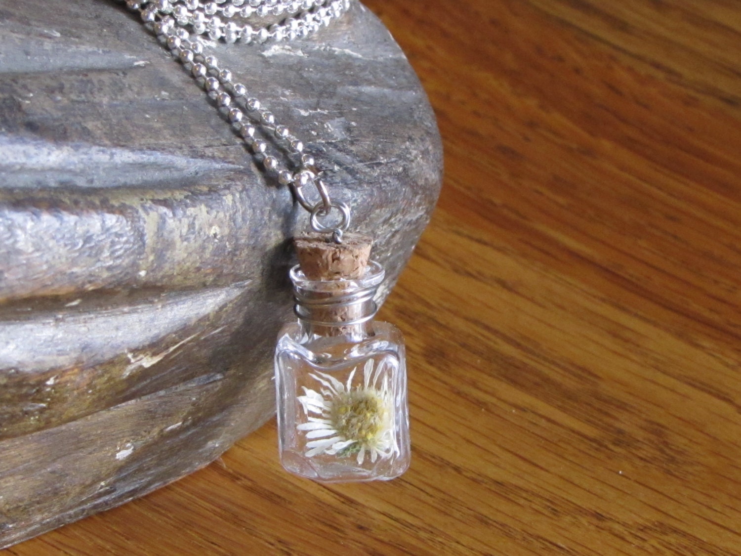 He Loves me... a dried miniture like daisy in a wired wrapped capsule
