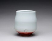 handmade porcelain cup, yunomi, tumbler with light turquoise celadon and bright red glazes