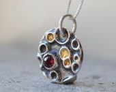 Garnet necklace in silver with gold details. Wine red garnet pendant with 22k gold details. January birthstone.