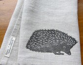 linen tea towel block printed with graphite hedgehog on toast linen