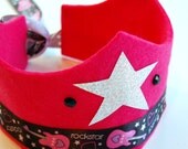 eco friendly vega rockstar crown in hot pink felt with silver star, black gemstones, and adjustable ribbon tie.  get ready to rock.
