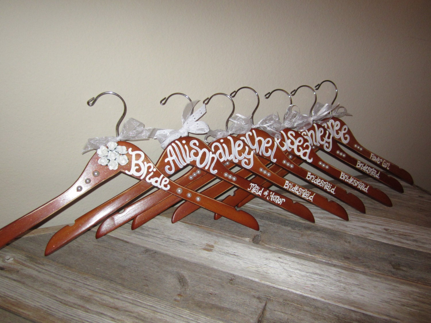 cherry wood stained hand painted hangers for bridesmaids, flower girls, brides, grooms, groomsmen, and mothers