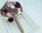 bridesmaid bouquet in purples and ivorys and white lace with rhinestone brooch