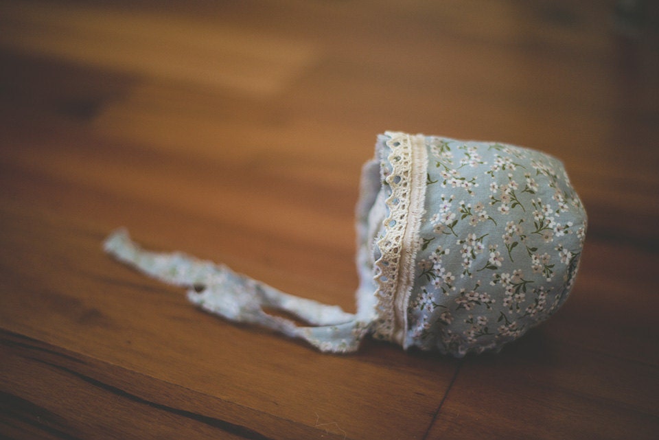 Light blue newborn bonnet with floral accents
