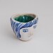 Girl's head tiny ceramic bowl in blue, white and turquoise