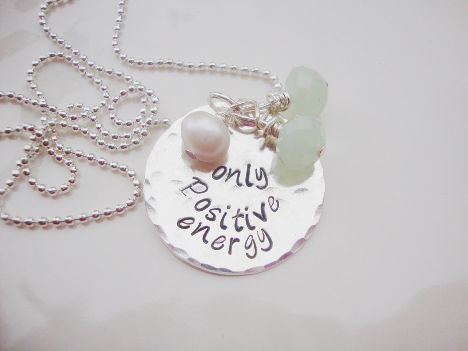 Positive energy hand stamped silver necklace with opaque green czech glass beads and feshwater pearl