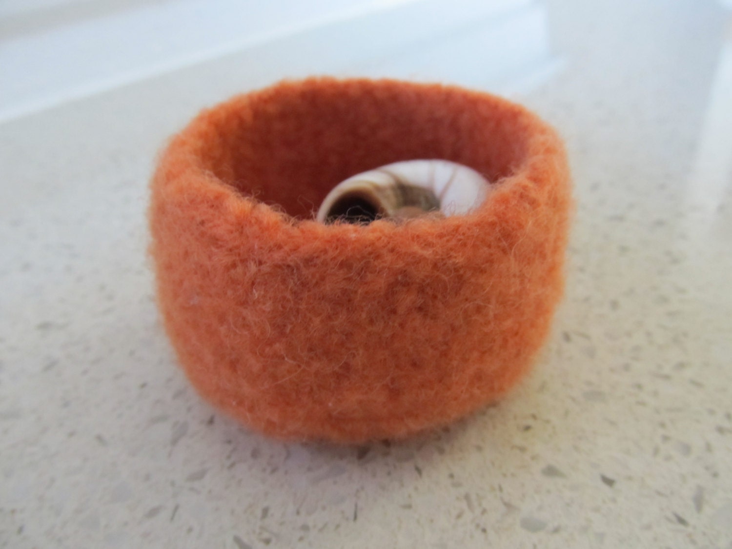 Very small felted dusty orange wool bowl