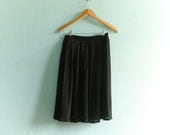 Vintage semi sheer black skirt / pleated / lined / short / knee length / medium