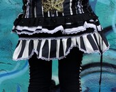 Adjustable Triple Corset Mini Ruffle Skirt with 2 hidden front pockets. Silk Screen by Brianne Tweddle