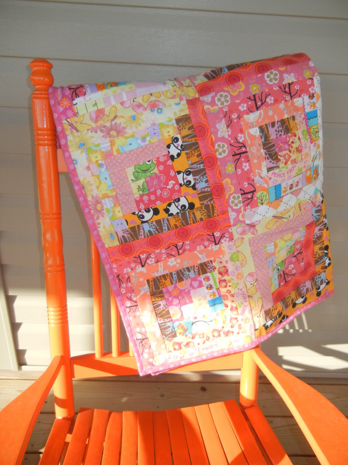 Little Girl Crib sized flannel quilt in oranges, browns, pinks, greens, blues, yellows.  Ready to ship.