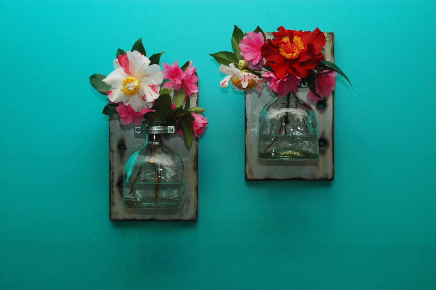 floating vases made from recycled bottles and repurposed wood