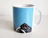 Bright blue mug with lino print design