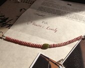 Adornment Bracelet: Pink Pearls and Green Focal Bead