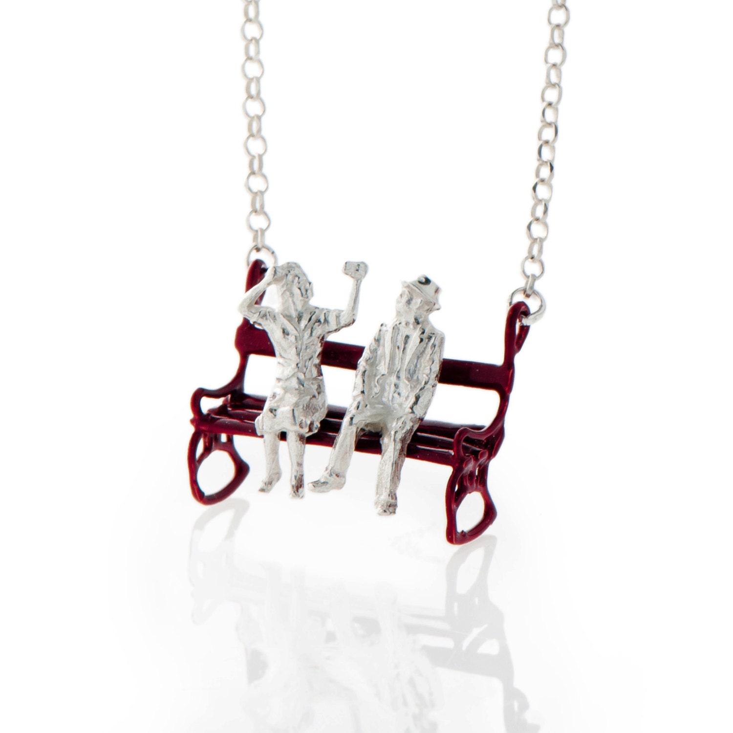 Silver necklace with a lovely couple sitting on a Bourdeaux Bench