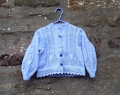 Hand knitted girl's blue lacy patterned cardigan with fancy edge. 22" chest
