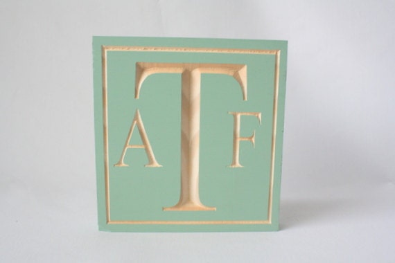 Monogram personalized wedding cake topper, shown in mint green, seafoam, celedon
