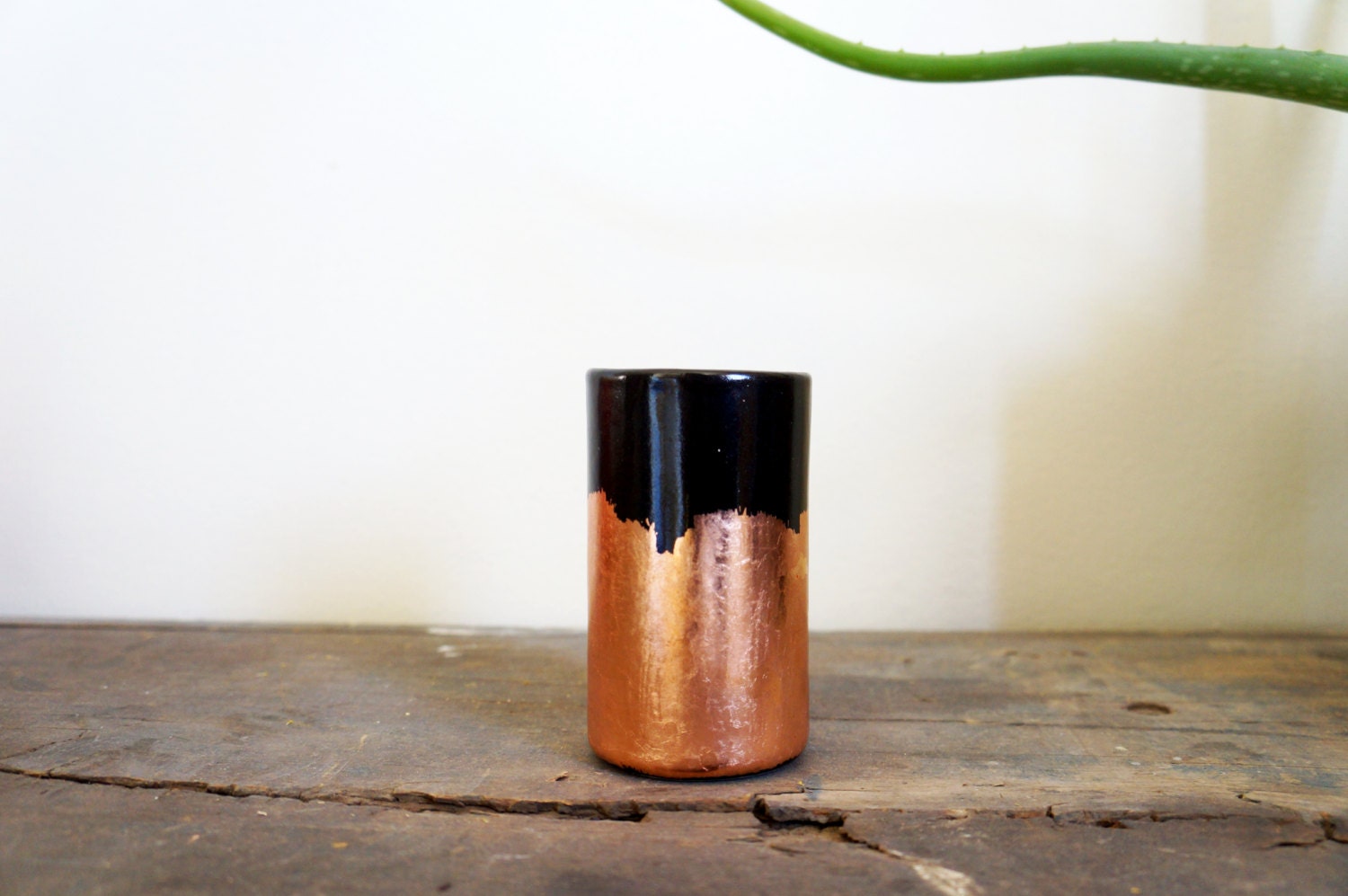 black vessel with copper brush strokes