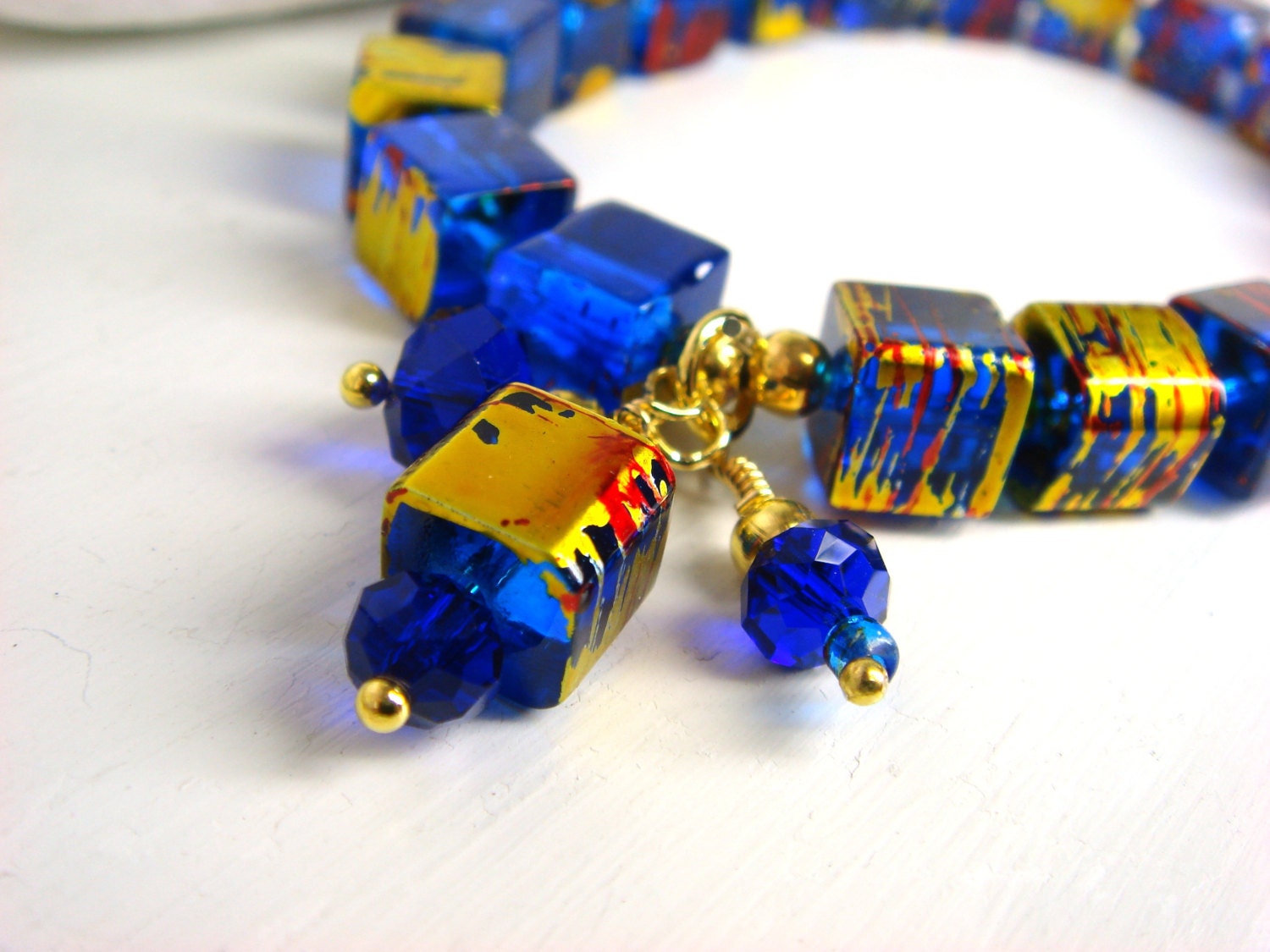Blue Cube Glass Bead Stretch Bracelet, royal blue with gold spacers and Crystals.