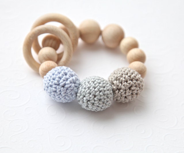 Teething toy with crochet wooden beads and 2 wooden rings. Light grey, pale blue, beige alternately small and big wooden beads rattle.