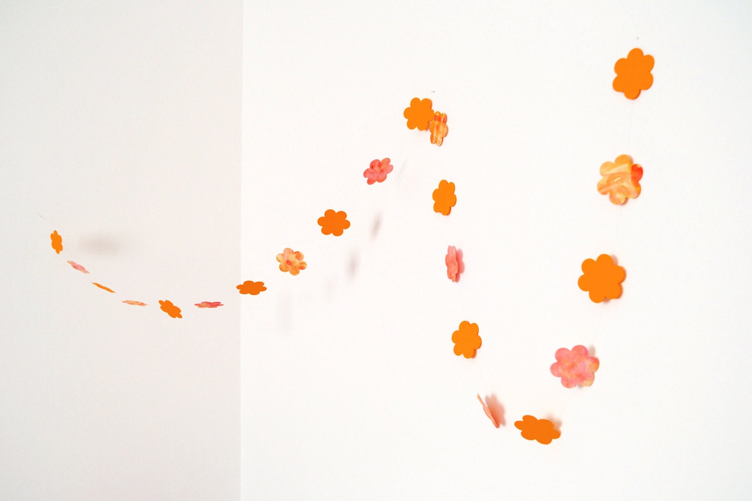 Orange garland in cardboard flowers