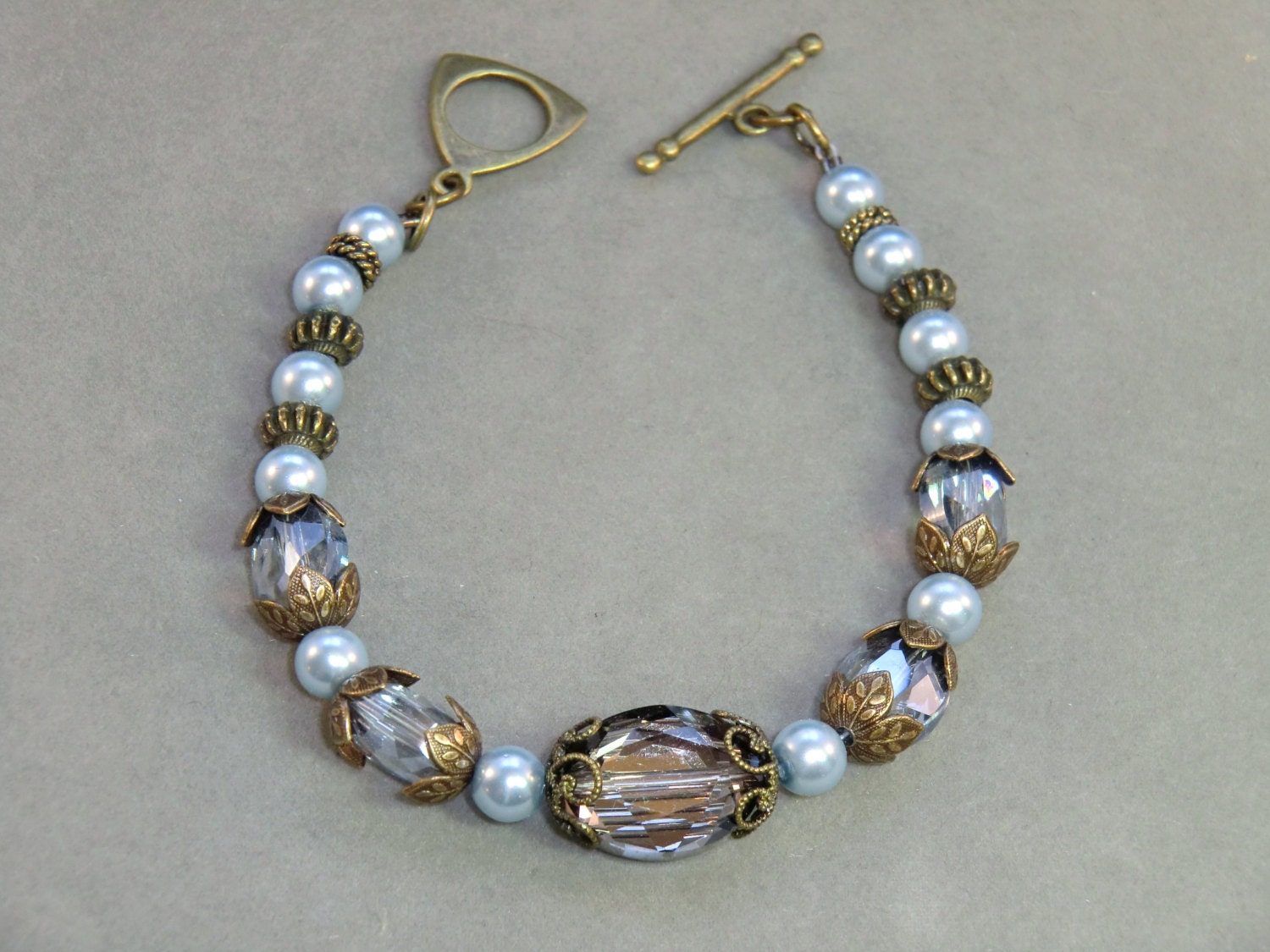 Grey blue crystal and pearl antique brass bracelet,  brass filigree blue crystal bracelet vintage style