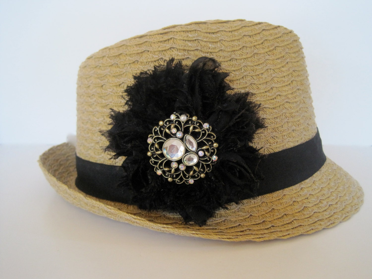 Packable Fedor Hat in Wheat/Tan with Black Shabby Chiffon Flowers and Gold and Rhinestone Pendant Accent