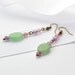Green Oval Aventurine dangle drop gemstone earrings topped with twin round Purple Fluorite beads