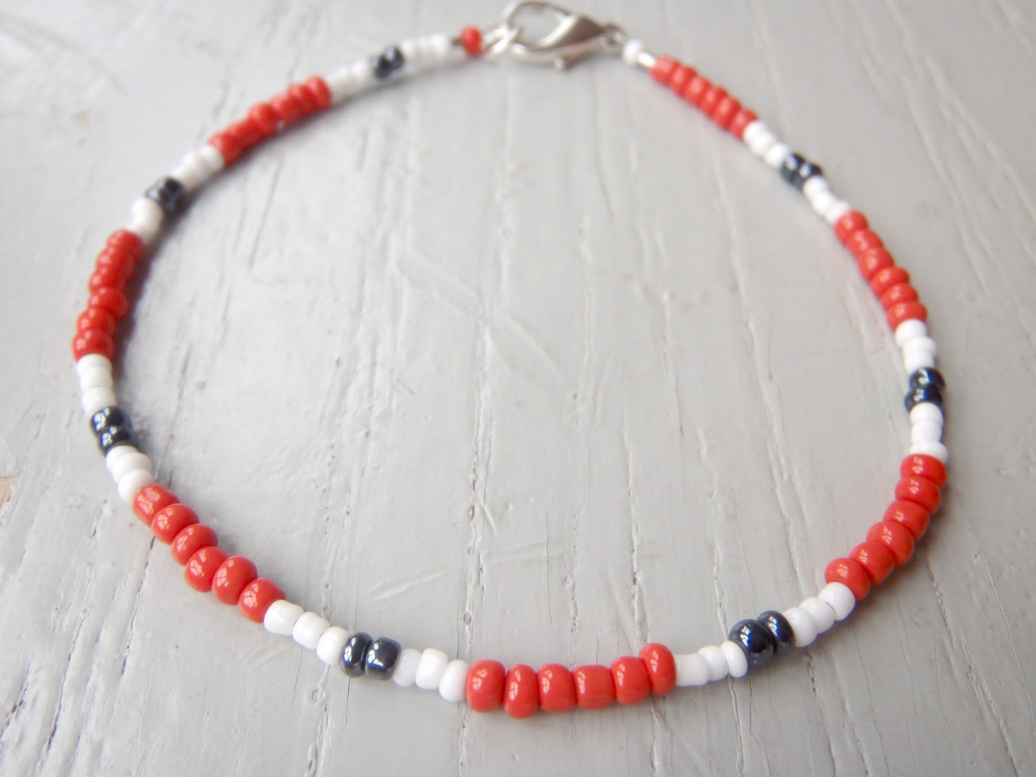 anklet in tangerine, white and grey gunmetal