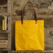 Oversized tote. Thick leather straps. Washed yellow canvas. Grey linen lining.