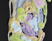 abstract shampoo composition consisting of PALE colors on black paper