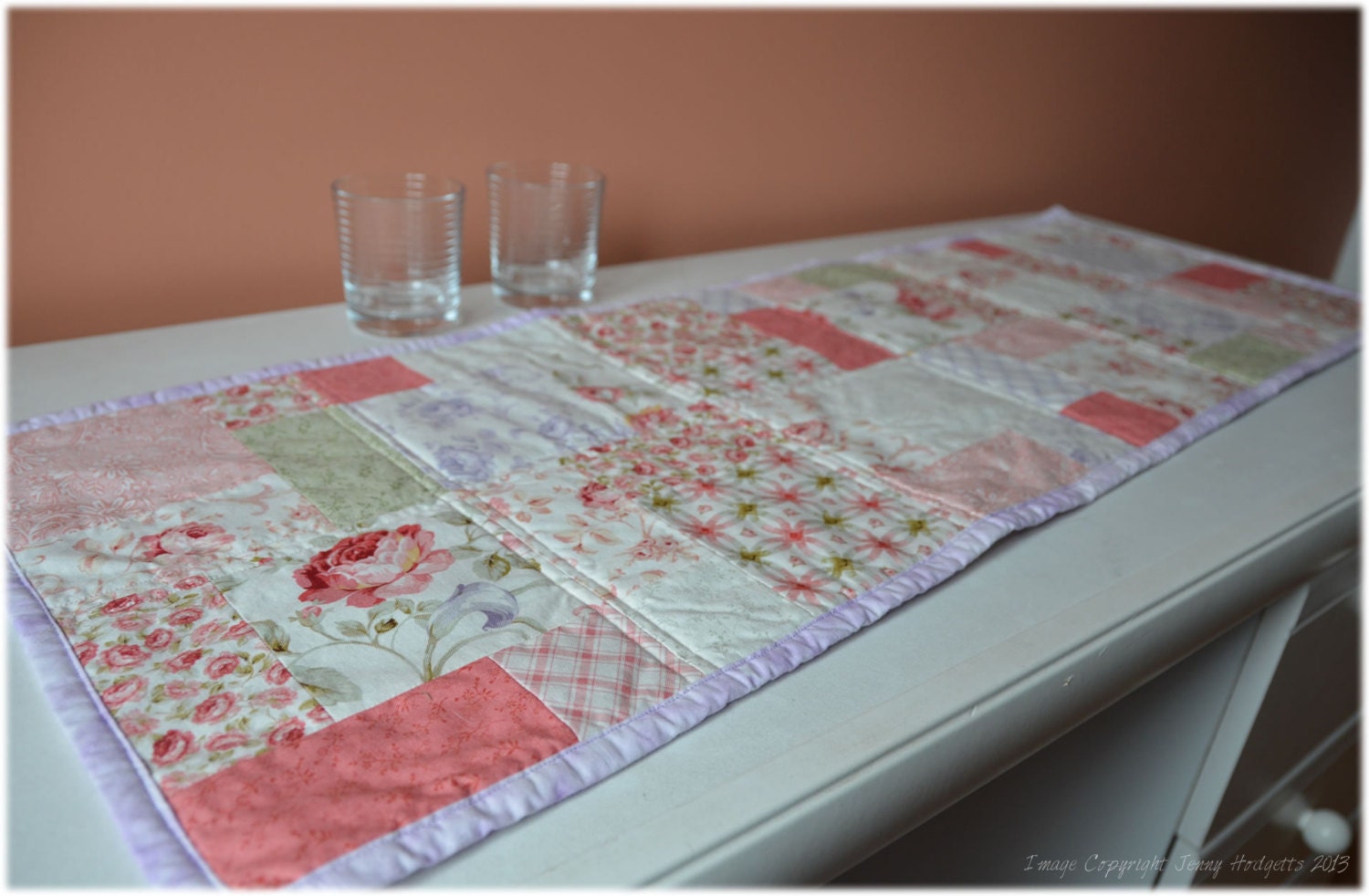 Country cottage decor quilted table runner.  Traditional patchwork in a rustic shabby chic style.  Soft pink, green & lilac.
