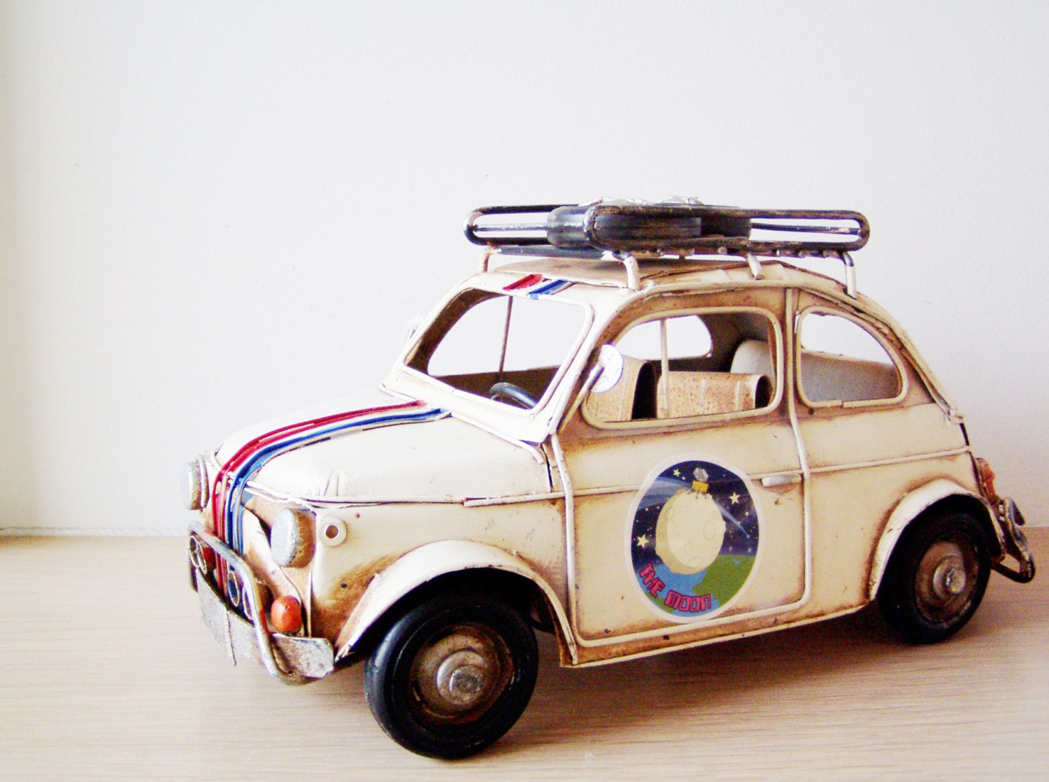 Battered Fiat car miniature with stripes and stickers, metal car retro collectible miniature