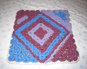 Multicoloured  Cushion cover. Handmade with acrylic wool. Purple, green, orange, light-blue, light-brown, lavender.