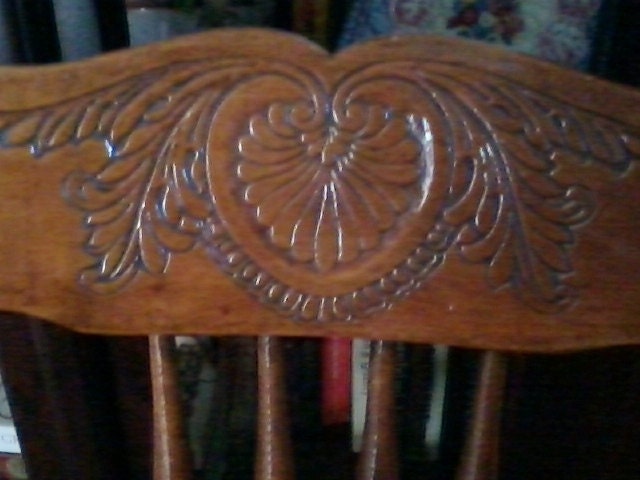 Late 1800's solid wood child's chair with beautiful carved back