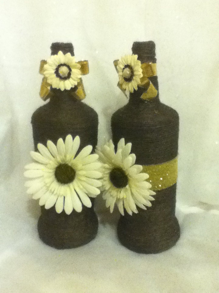 Black twine wrapped wine bottle with Gold ribbon and White Daisy's