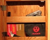 Wall mounted hidden gun storage