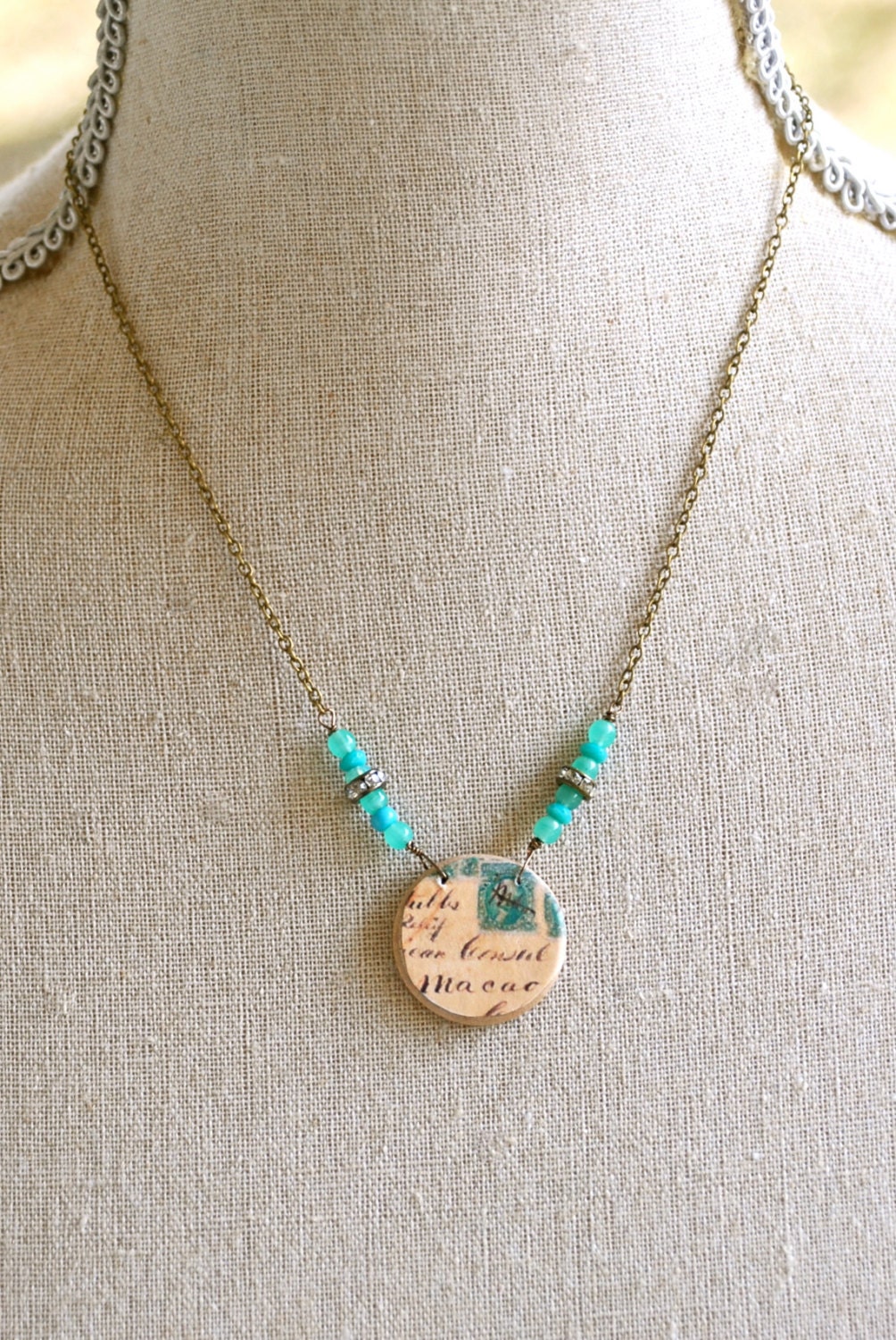 Souvenir.stamp circle pendant,rhinestone,glass beaded necklace. TIedupmemories