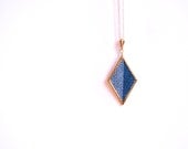 gold geometric diamond shaped necklace // cross stitched blue and white