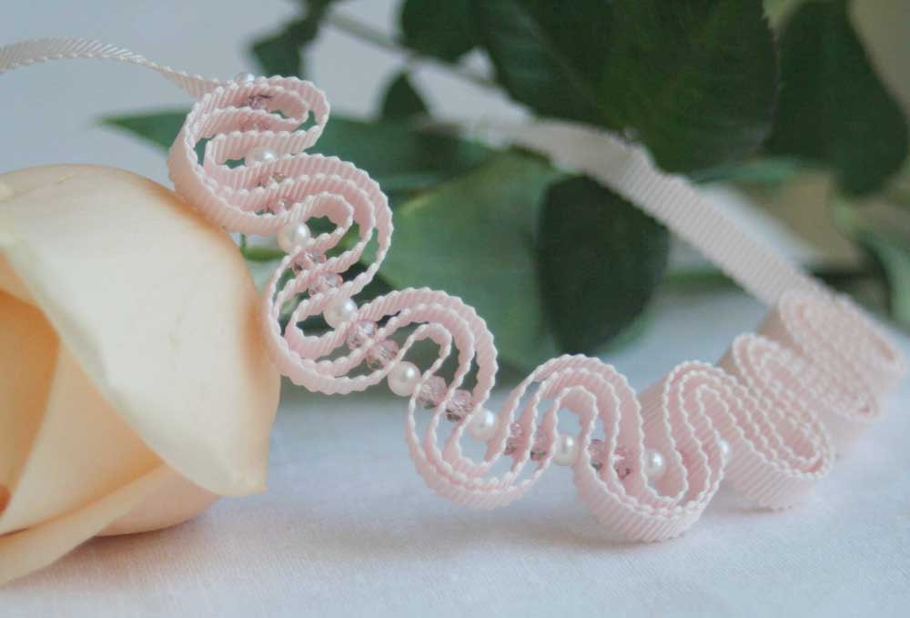 Delicate pastel pink grosgrain ribbon with pearls and crystals.