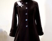 Black fleece coat with damask buttons and gorgeous rose corsage.