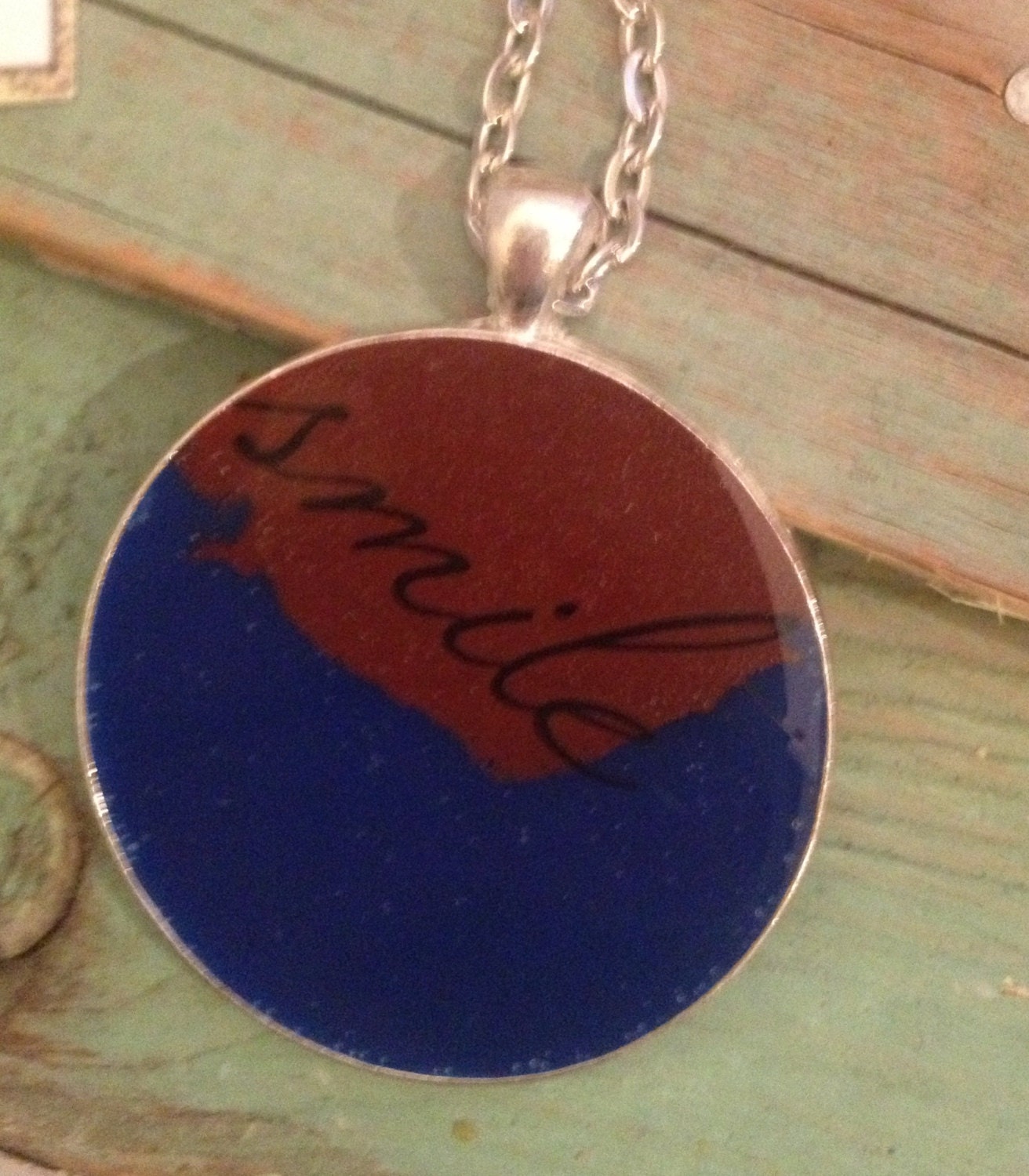 Electric blue and maroon resin pendant necklace with quote 'smile'. Large round 38mm