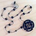 Asian black metal pendant on black glazed bead necklace