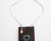 Black glitter geometric wood pendant necklace. Silver metal chain, copper, blue beads, pink drop