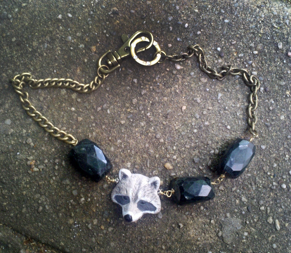 a Snickers For Terilyn - Black Serpentine and sculpted Raccoon head beaded brass necklace